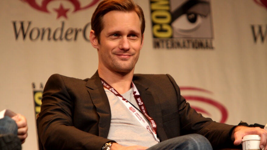 Actor Alexander Skarsgard sitting at an event, looking out into the audience