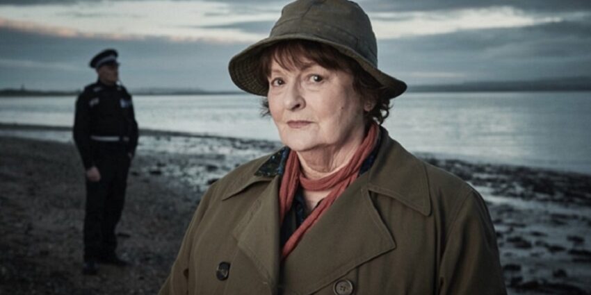 Brenda Blethyn in character as detective Vera in the ITV drama, standing on a beach