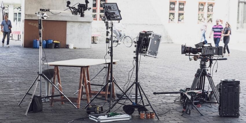 Cameras and film equipment outside on cobbled street