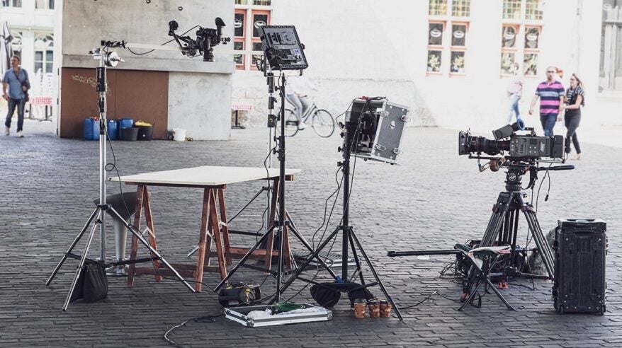 Cameras and film equipment outside on cobbled street