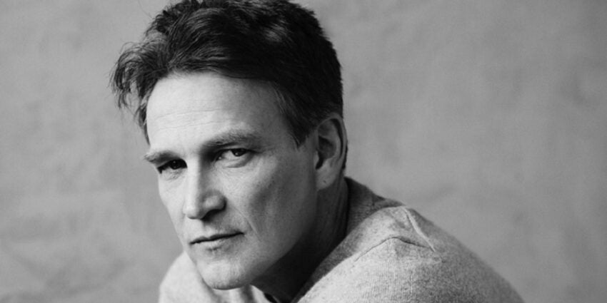 Black and white close-up of actor Stephen Moyer in pale grey sweater