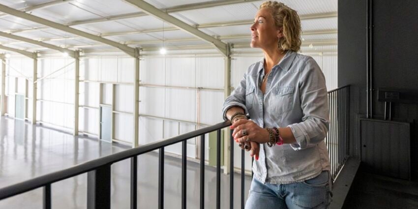 Presenter Sarah Beeny looking out from a gallery into a studio space