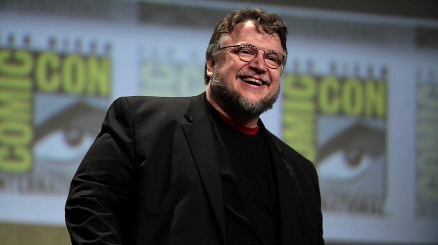 Director Guillermo del Toro smiling, wearing a dark sweater and jacket