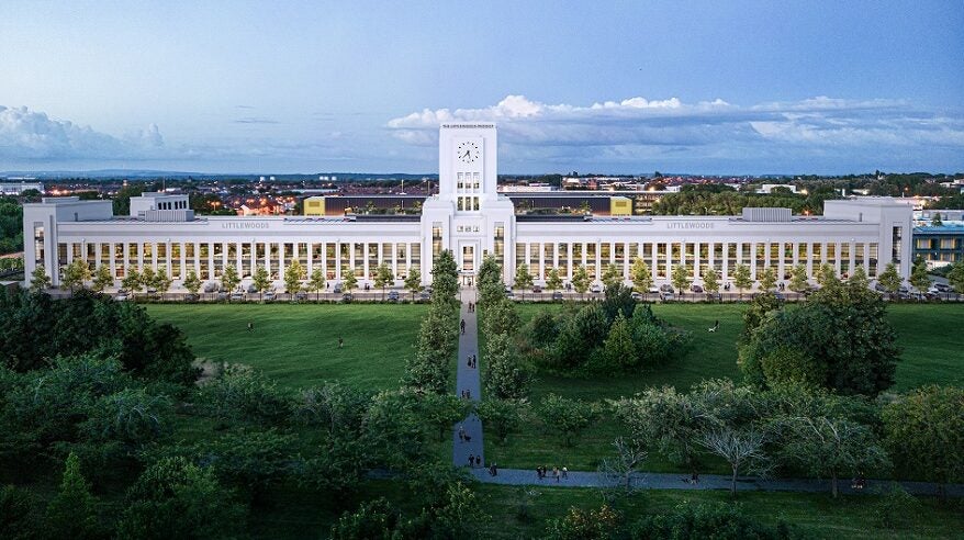 Long-range view of stunning white Art Deco Littlewoods building with sky above and grass below