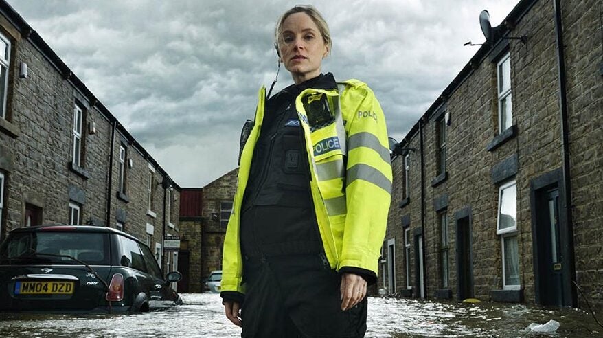 Actor Sophie Rundle in character in flooded street, in ITV drama After the Flood