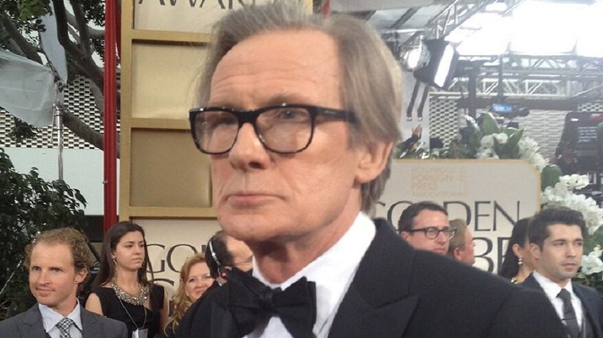 Actor Bill Nighy standing in a crowd, wearing a tuxedo