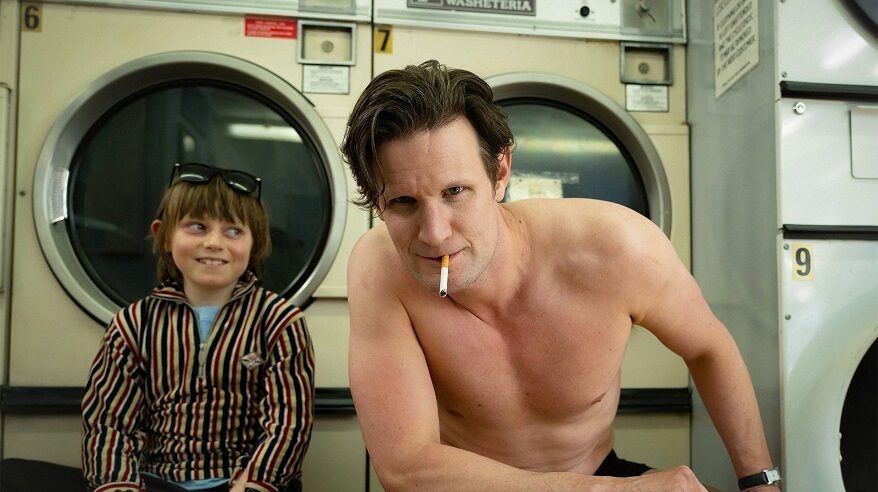 Matt Smith as Bunny Munro, topless in a laundrette with young actor playing his son next to him, in image from Sky drama The Death of Bunny Munro