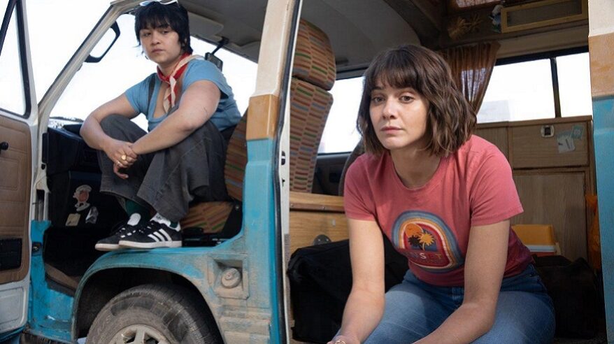 Actors from drama The Road Trip, sitting in a campervan looking out through the open doors