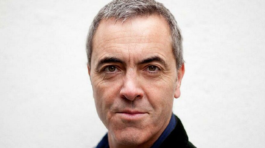 Headshot of actor James Nesbitt looking into the camera in a dark shirt