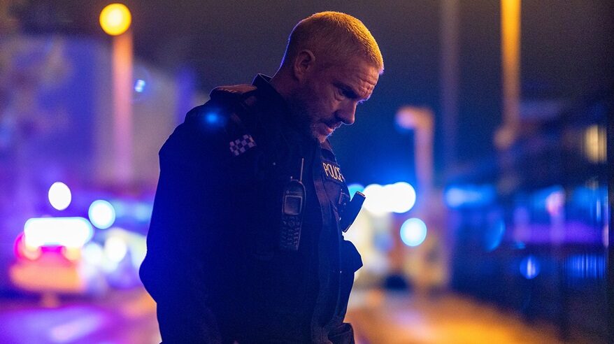 Martin Freeman in character as cop Chris in drama The Responder, standing on a dark street