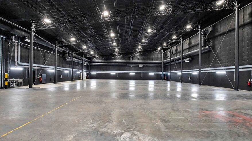 Interior of a new sound stage for filming, with bright lights and a shiny floor