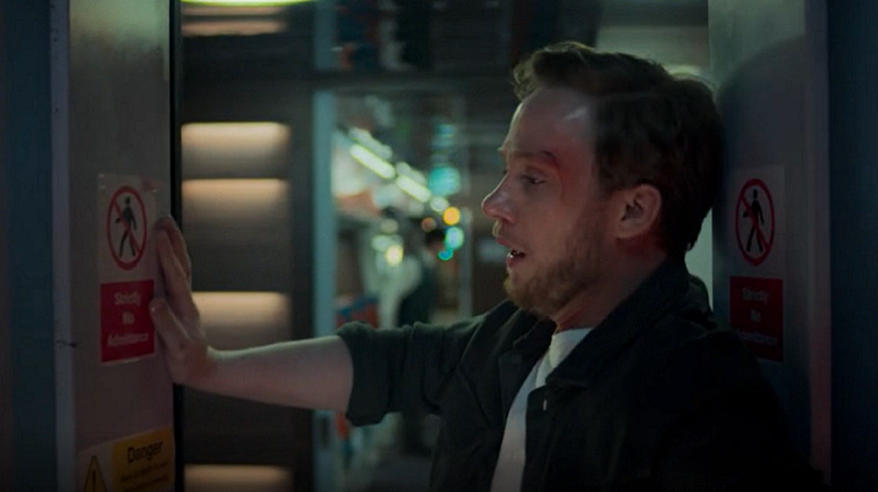 Actor Joe Cole looking terrified in a train doorway in BBC drama Nightsleeper