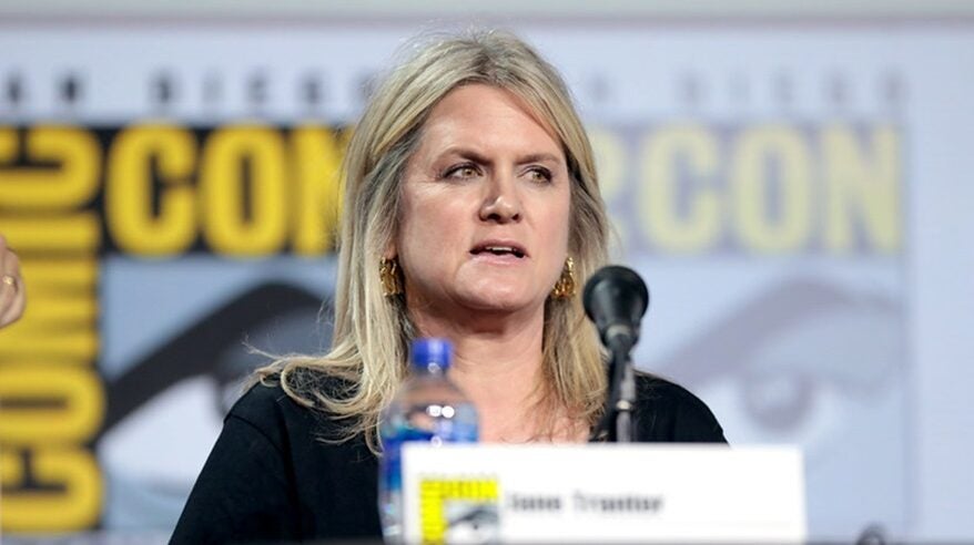 TV producer Jane Tranter at a desk with microphone and bottle of water