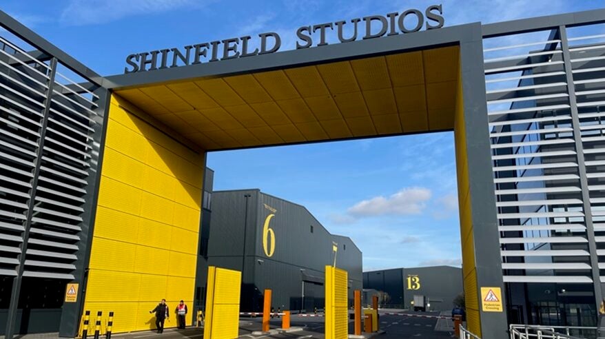 Large yellow, branded gateway to Shinfield Studios