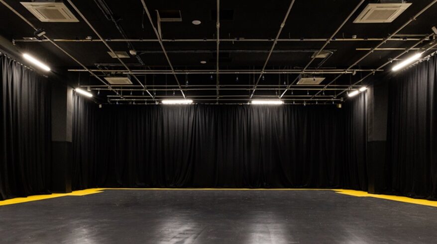 Film and TV studio, dark walls and ceiling lights