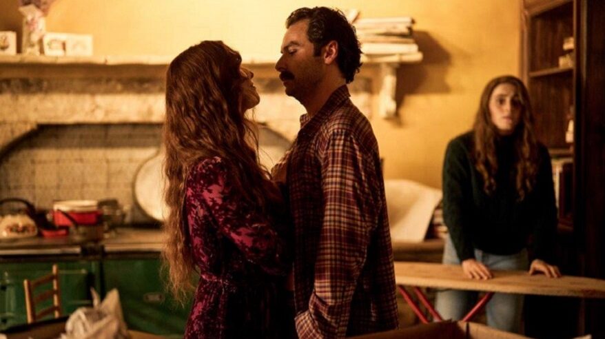 Actors in character in Disney+ drama Rivals stand facing each other very close together