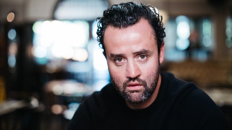 Actor Daniel Mays with dark hair and beard and wearing black sweater