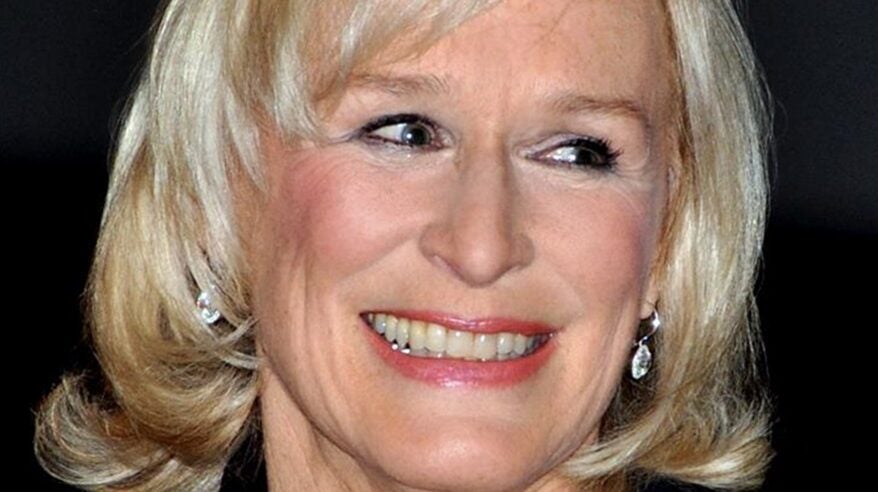 Close up of actor Glenn Close with shoulder-length wavy blonde hair and head turned slightly to side