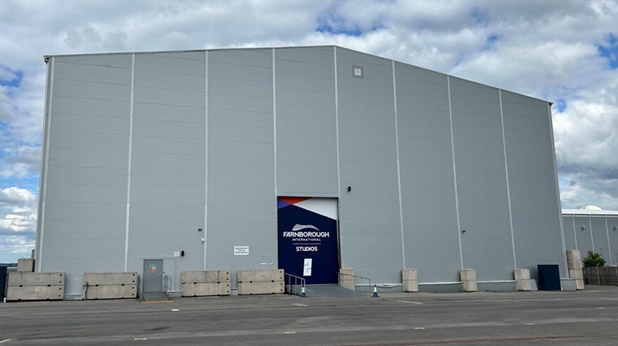 Large grey film sound stage building on hardstanding