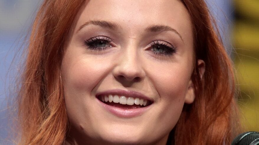 Red-haired actor Sophie Turner in close-up, looking directly into camera