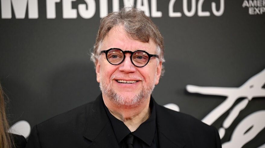 Photo of a man with brown hair, black spectacles and dark clothes attending a film festival